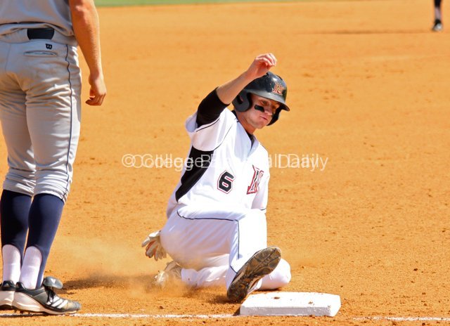 Kyle Attl slides into third base.