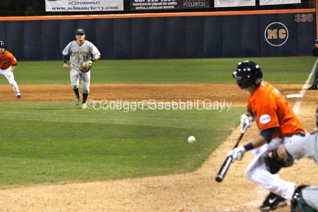 Ryon Healy charges as Keegan Dale lays down a bunt.