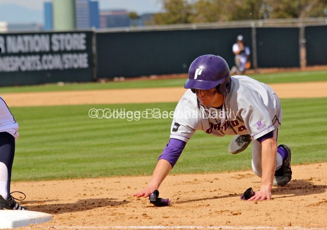 Michael Lucarelli dives back into first base.