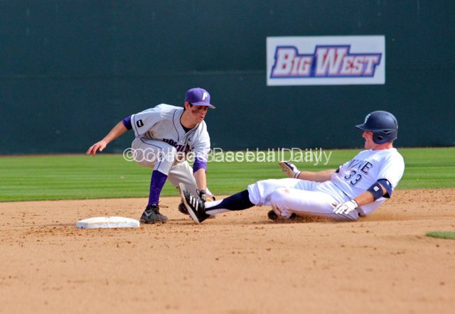 Michael Lucarelli applies the tag to Connor Spencer.