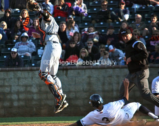Chad Wallach climbs the ladder to catch a relay throw.