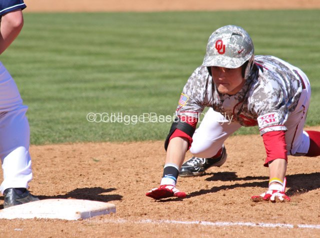 Craig Aikin dives back to first.