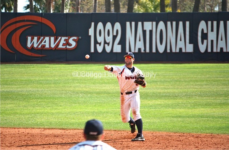 Joe Sever throws to first base to get a runner