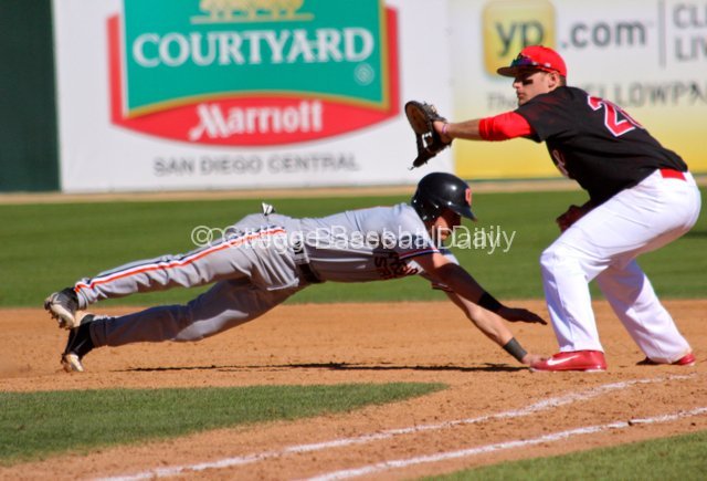 Nate Esposito dives back to first base.