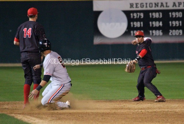 Tim Zier rares back to throw as Michael Conforto slides into second base.
