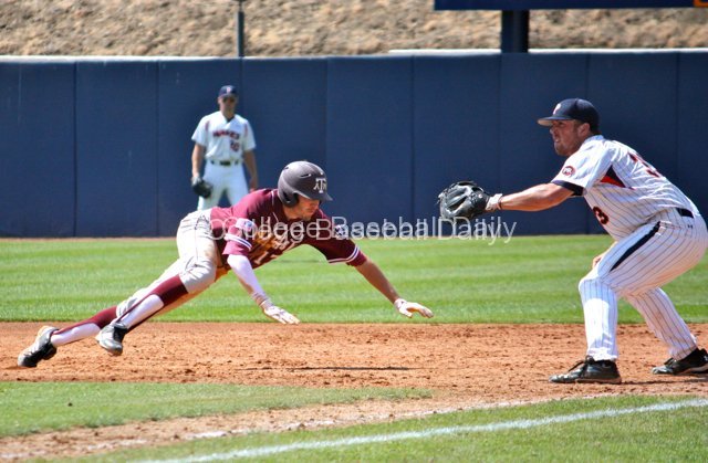 Matt Juengel dives back to first.