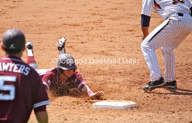 Mikey Reynolds dives into third base.