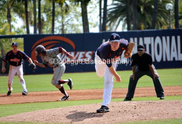 Mikey Reynolds steals third as Corey Miller delivers.