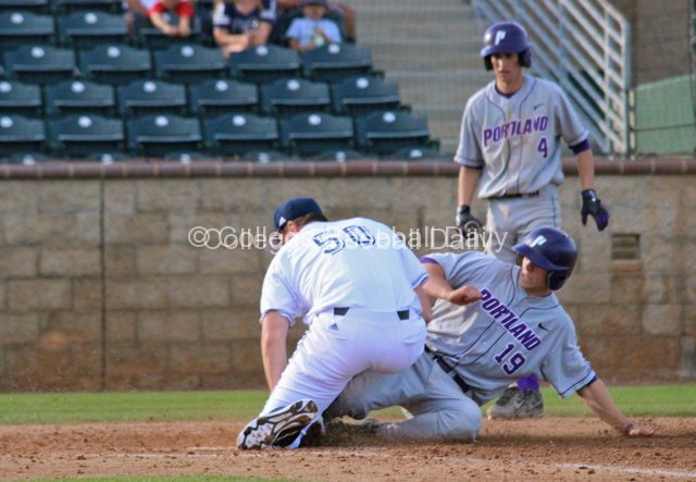 Ben Grubb slides in after a wild pitch.