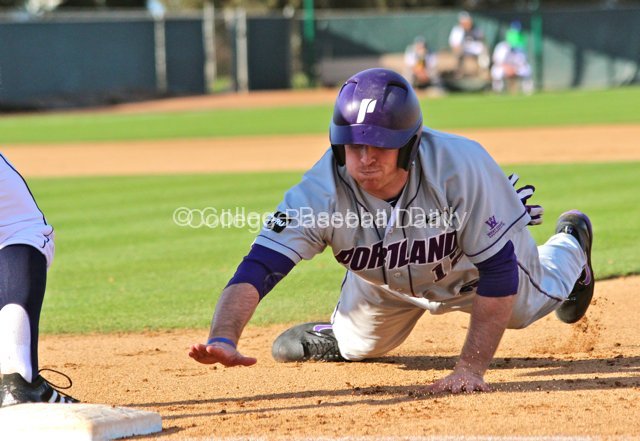 Kramer Scott dives back to first base.