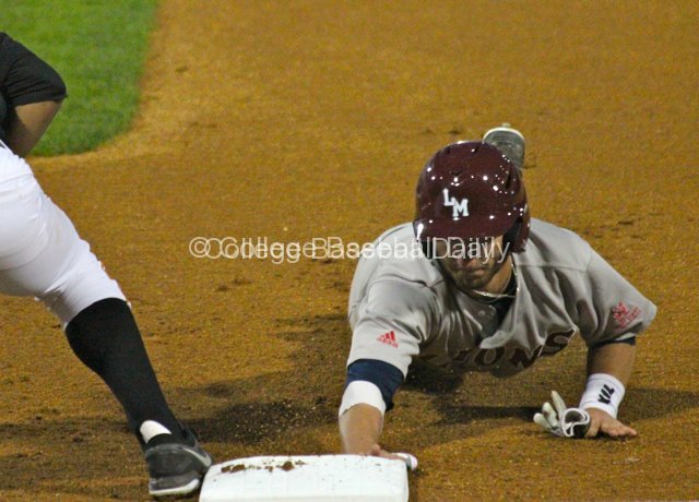 Joey Boney dives back to first.