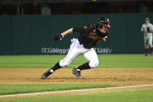 Adam Landecker dives back to first base.