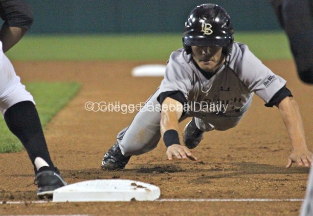 Colby Brenner dives into first base.