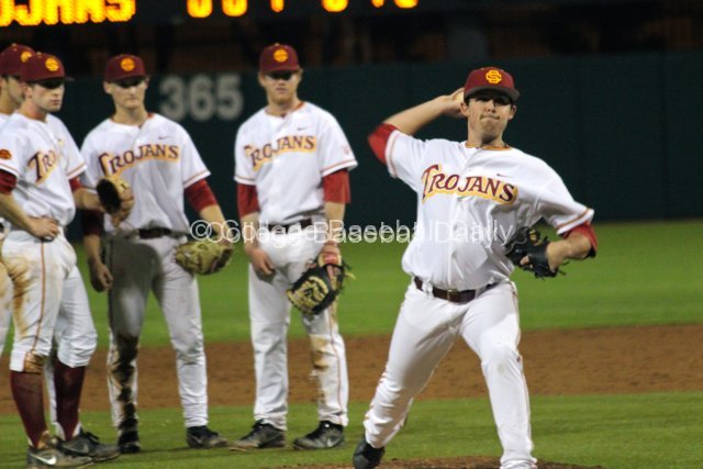 USC teammates look on as Kyle Davis warms up.