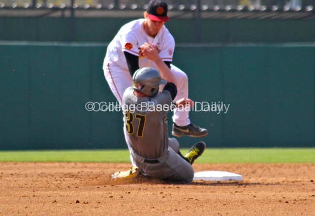 Adam Landecker jumps out of the way of the sliding runner.