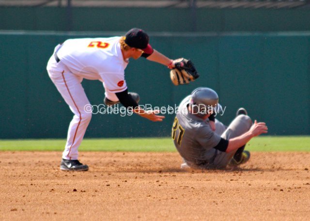 Adam Landecker avoids the sliding Mitchell Tolman.
