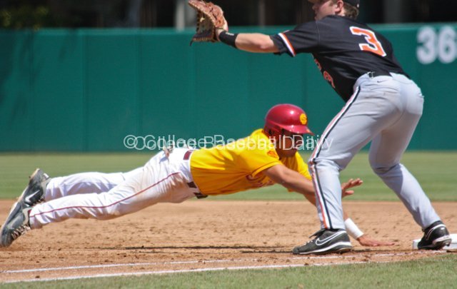 Andres Rodriguez dives back to first.