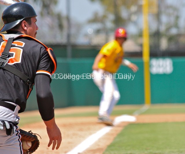 Ryan Gorton blocks a ball with a runner at third base.