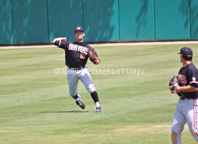 Dylan Davis tries to throw out a runner at the plate.