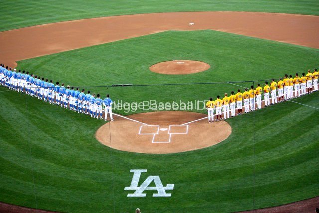 USC and UCLA line the field during the national anthem.