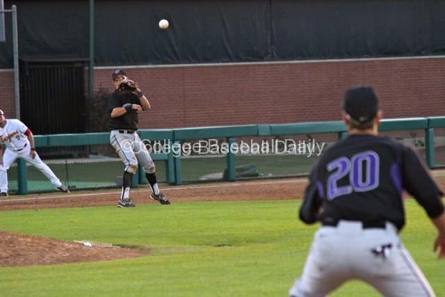 Jacob Lamb watches his throw to first.